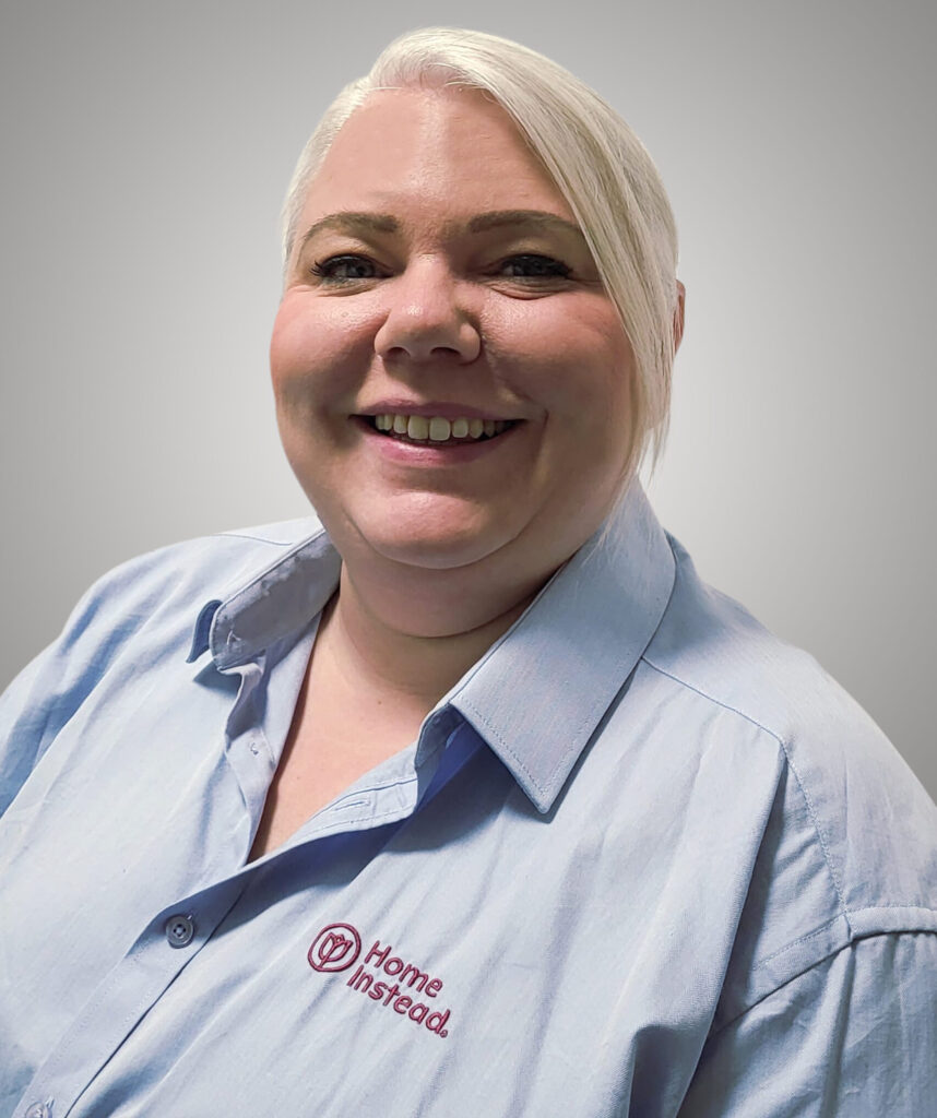 Frau mit blonden Haaren und blauer Bluse